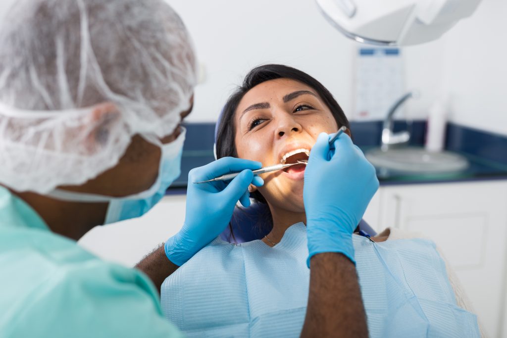 An image for a dental hygienist for our FAQ on What Is the Best Degree Path for Becoming a Dental Hygienist