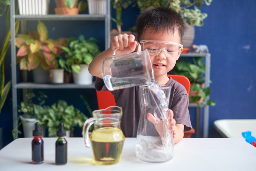 An image of a child conducting a science experiment for our Ultimate Engineering Game For Kids Resource Guide