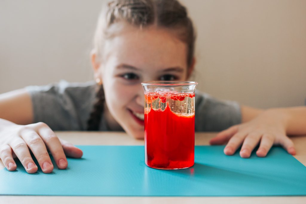 A girl doing a science experiment for our Ultimate Engineering Game For Kids Resource Guide
