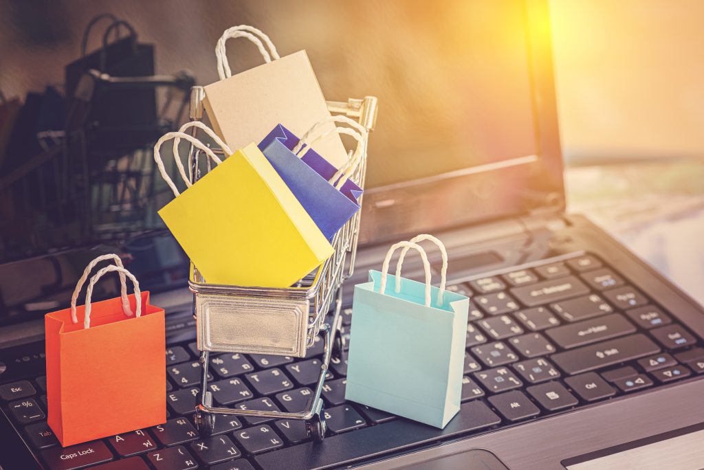 An image of colorful shopping bags on a computer for our article on Best Ecommerce Degree Path for a Successful Career