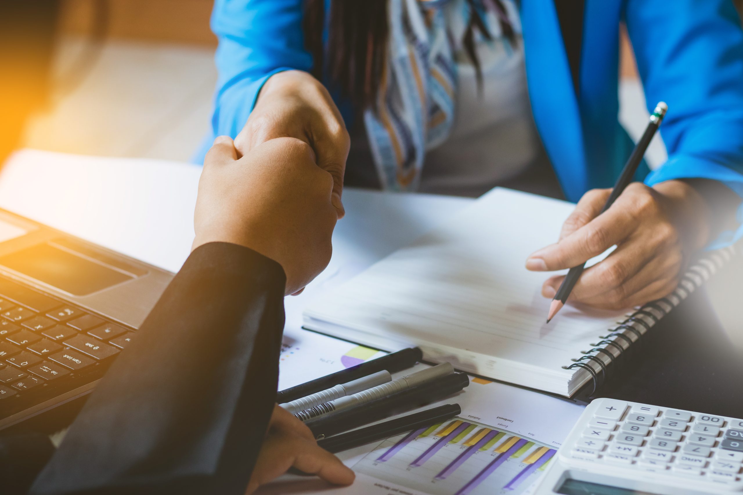 An image of a bank teller and customer for our FAQ on How to Become a Bank Teller With or Without a Degree