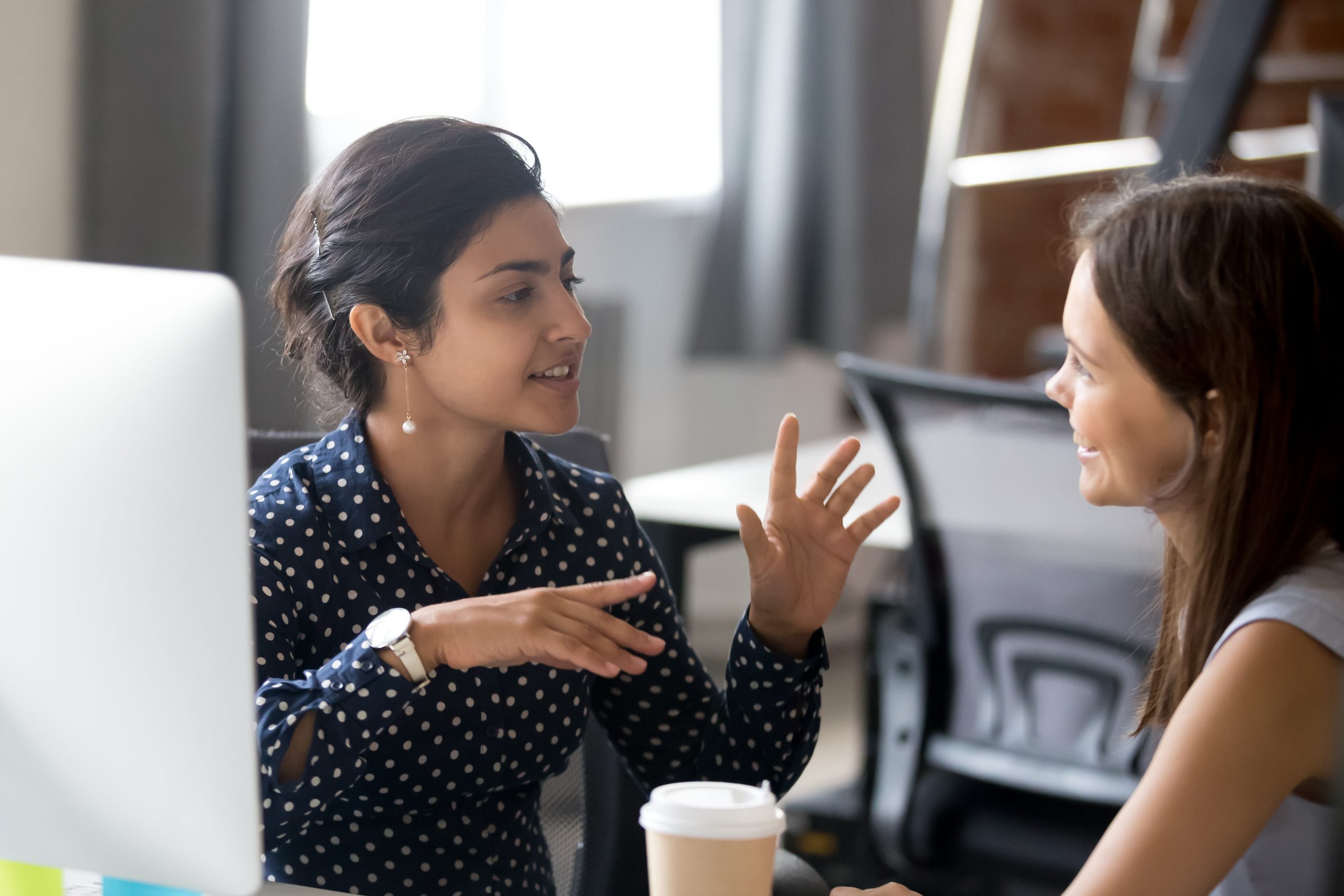 An image of two women communicating for our ranking of Top 30 Best Communications Degree Online Programs