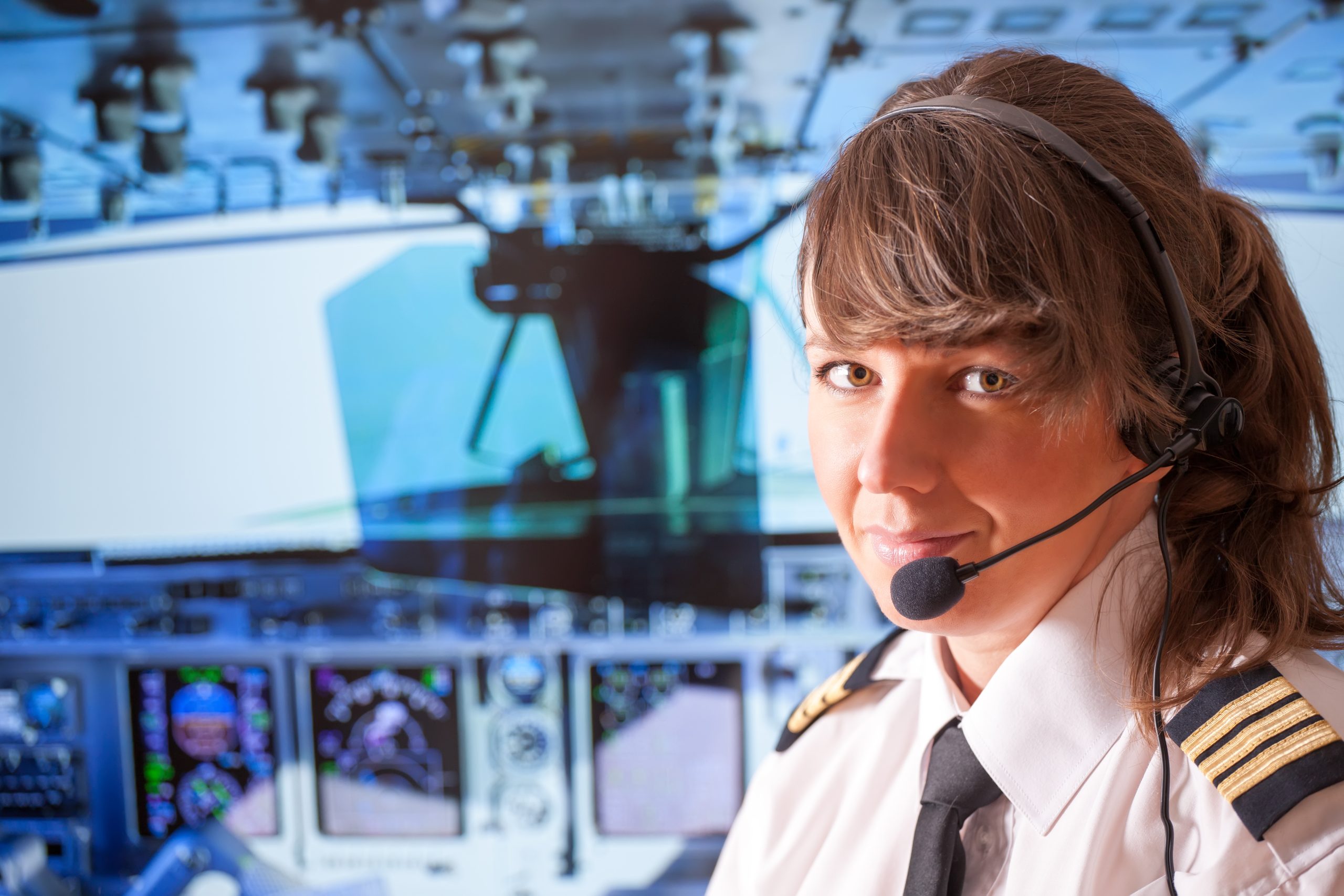 An image of a female pilot for our FAQ on A Guide to the Degrees and Schooling to Be a Pilot