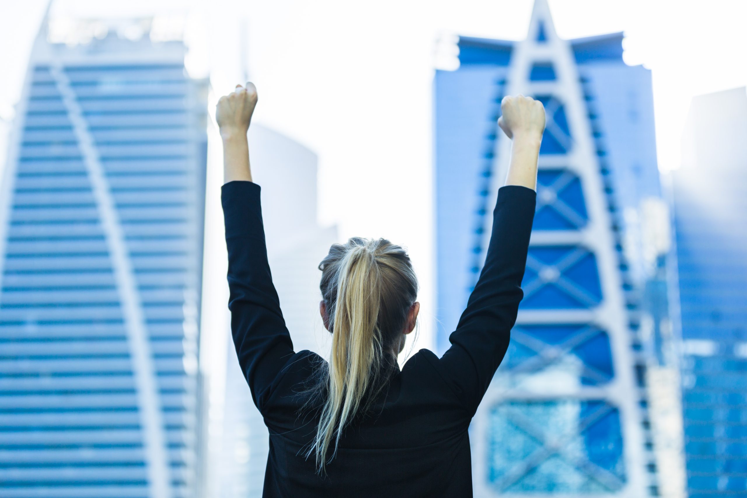 A woman with arms raised for our article on Top Ten Degrees for Adventurous People