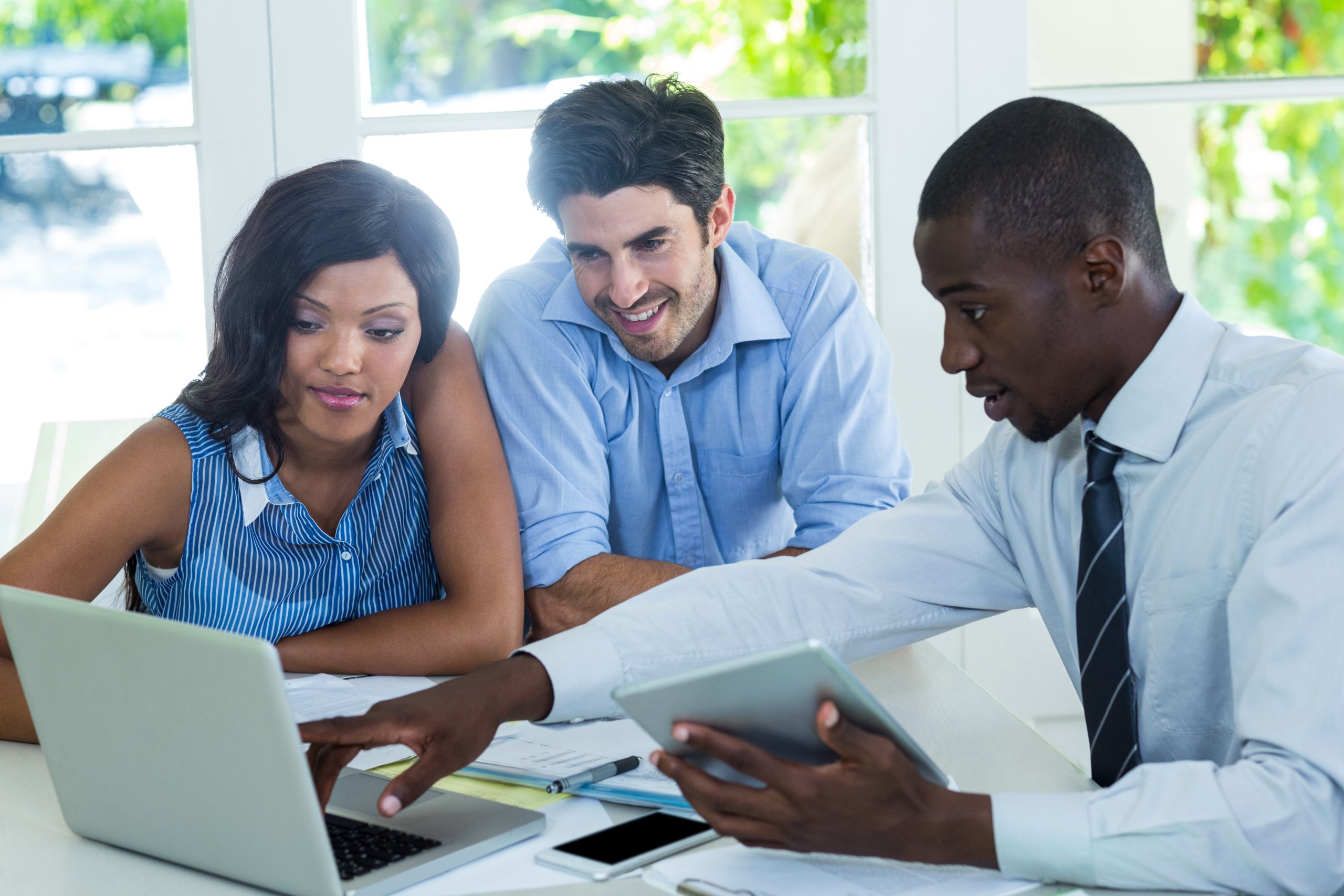 An image of a real estate agent and couple for our FAQ on Can I Be a Real Estate Agent with a Bachelor's in Finance