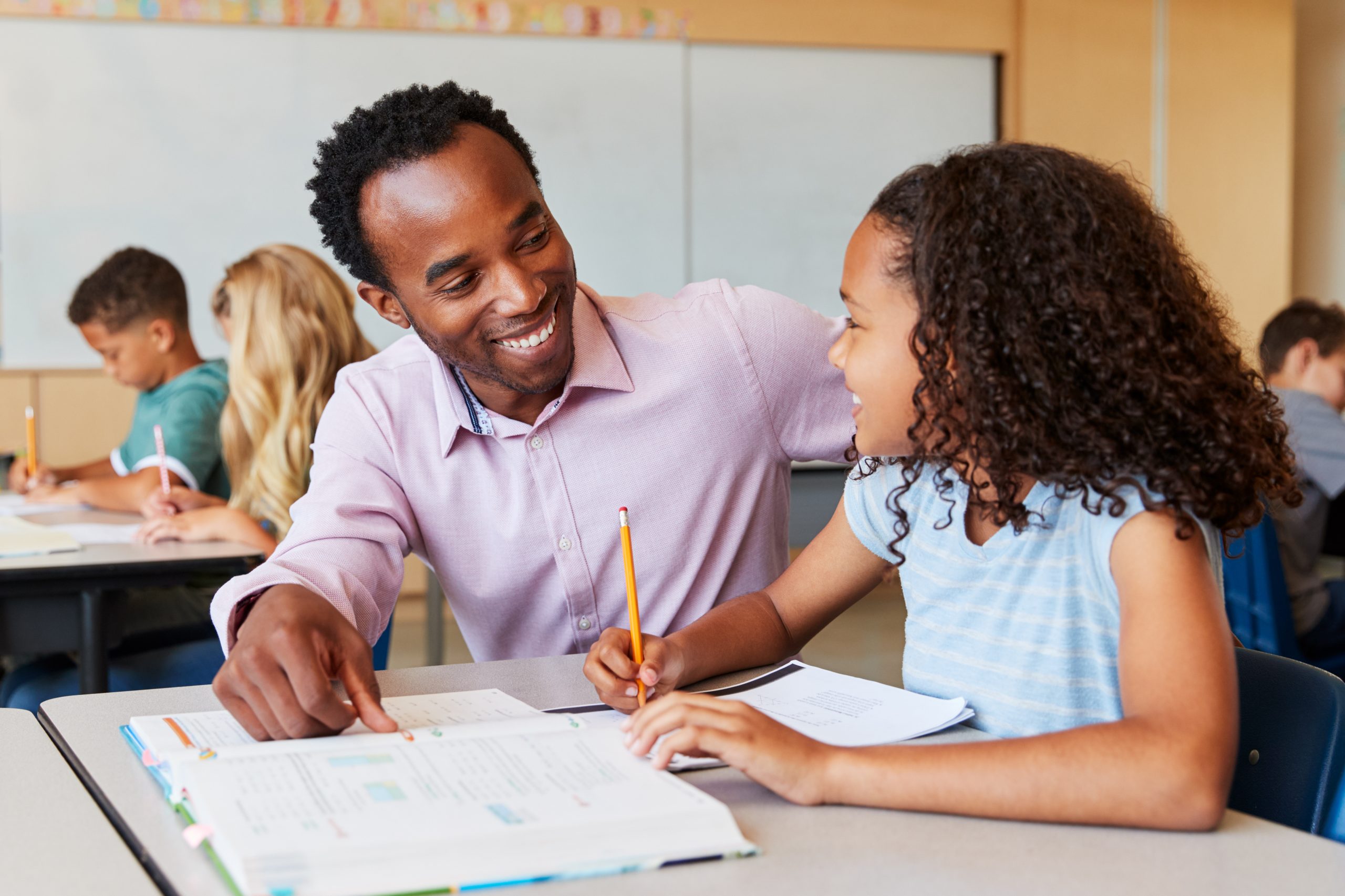 Image of a teacher with student for our Ultimate Guide to Education Degrees and Careers