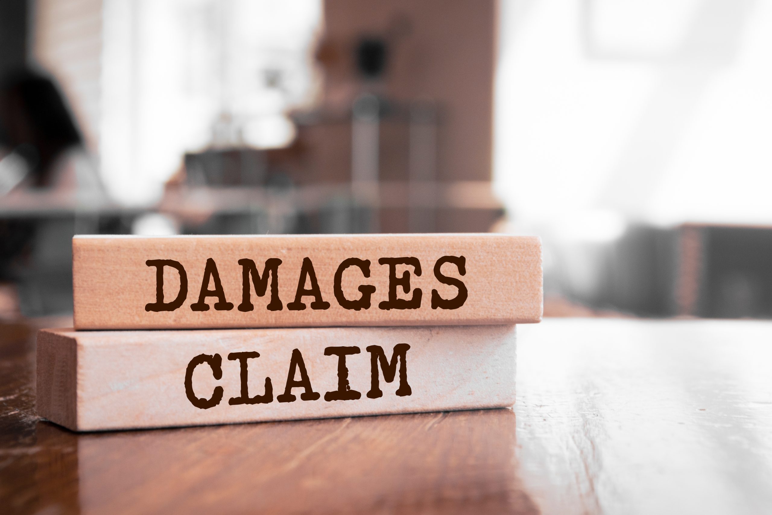 Image of wooden blocks with words for our FAQ on What’s the Best Degree Path for Becoming an Insurance Claims Adjuster