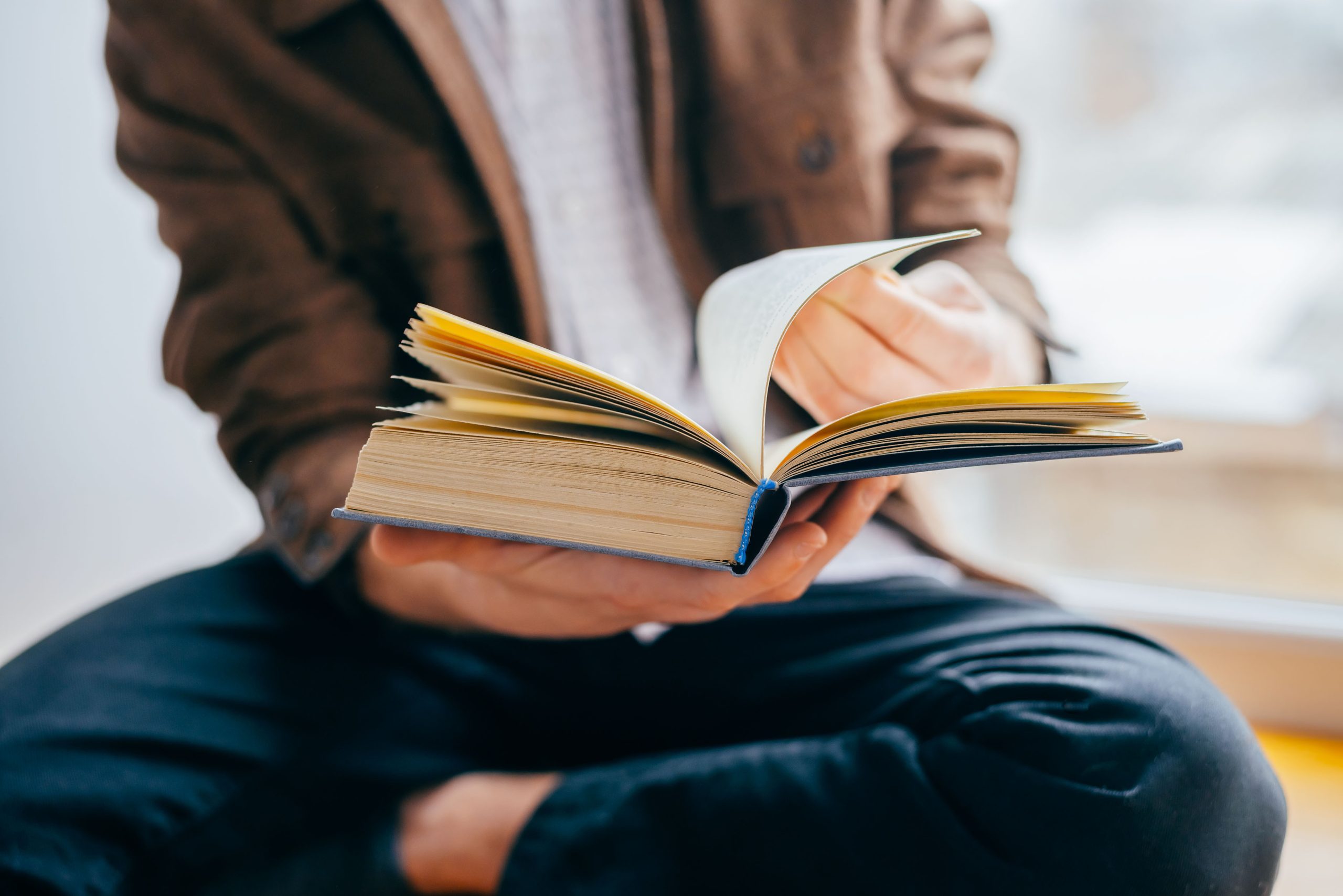 Image of man reading a book for our FAQ on Which Degree Programs Require the Least Amount of Reading and Writing