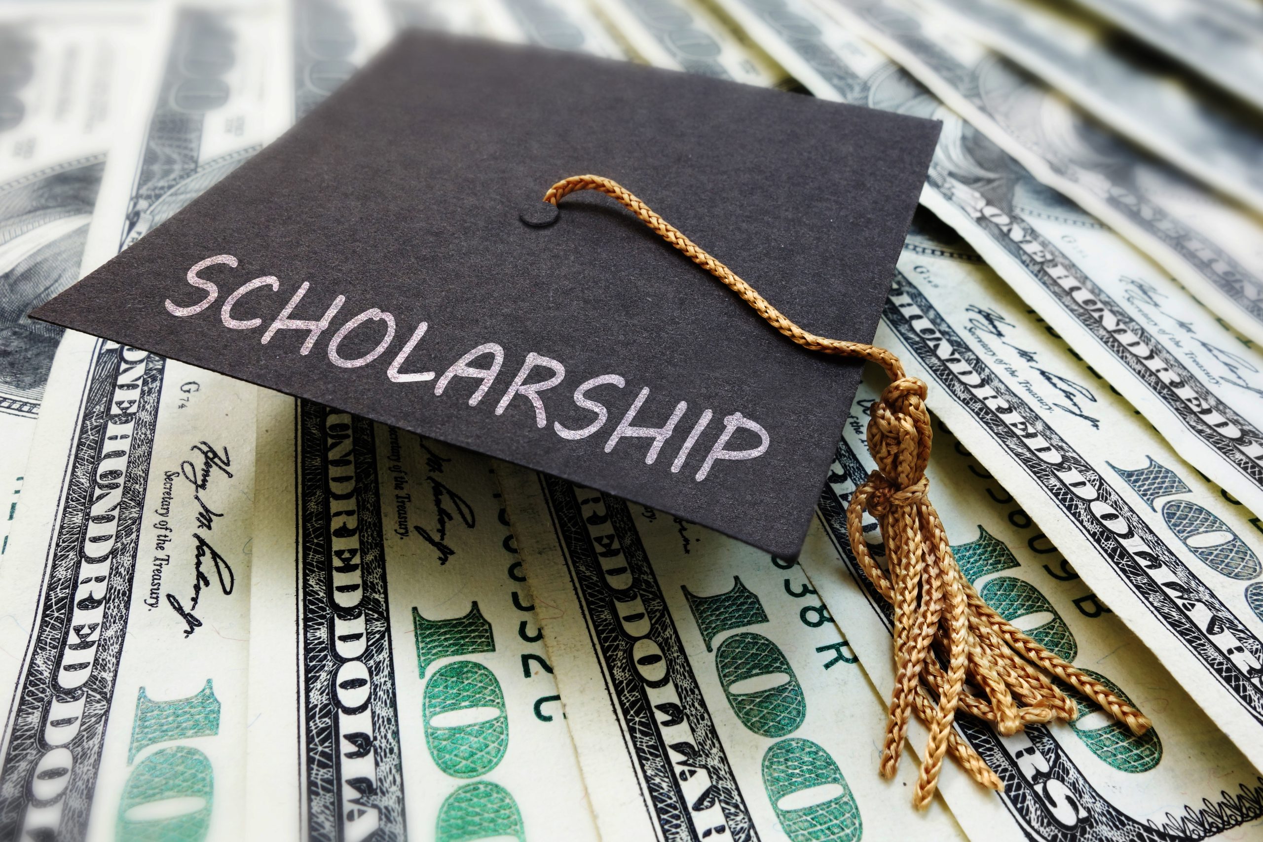 Image of mortar board on cash for FAQ on What are Some Research Grant and Scholarship Opportunities Available for Sociology Majors